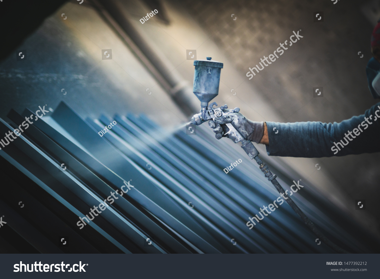 stock-photo-man-painting-metal-products-with-a-spray-gun-1477392212